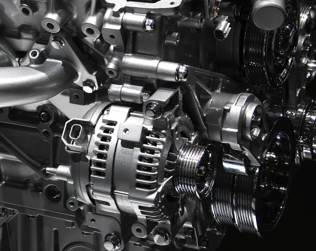 Car engine part - Close up image of an internal combustion engine.